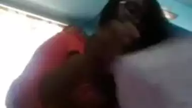 Smiling Indian with glasses listens to music and undresses at once